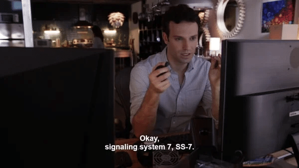 Still from Designated Survivor featuring an agent sitting in a chair in front of a computer preparing to hack into the SS7 network