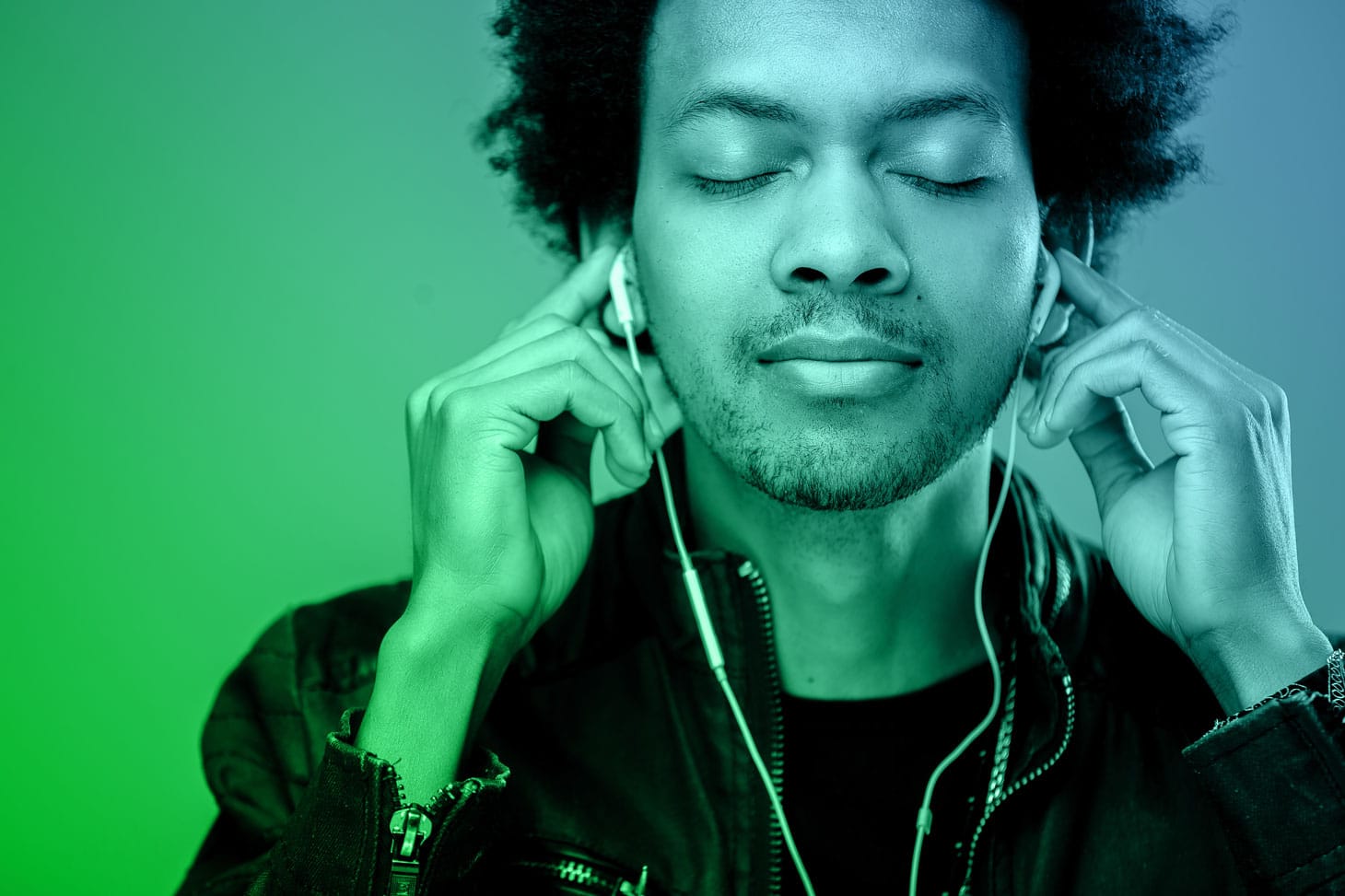 Man listening to music through earphones