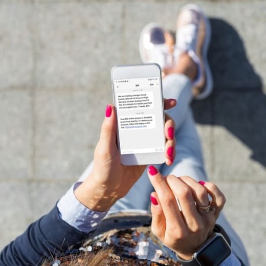 picture of woman from above showing her sending a text message from her mobile