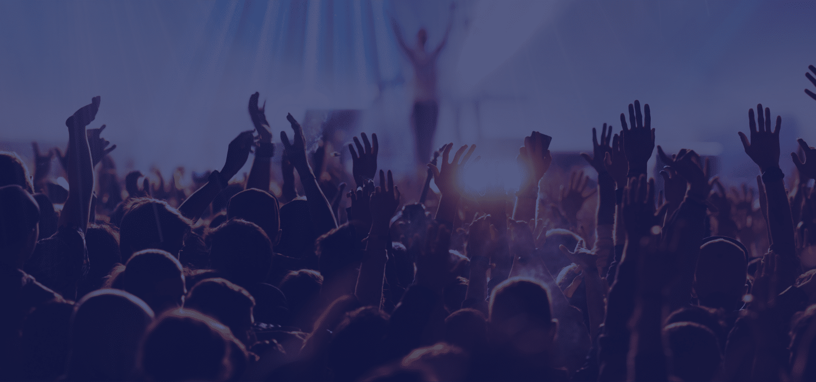 people at concert with hands up